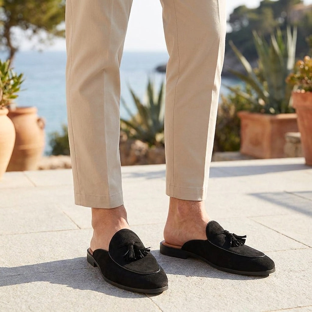 Pienza Suede Mules — Black, male model knee-down coastal terrace