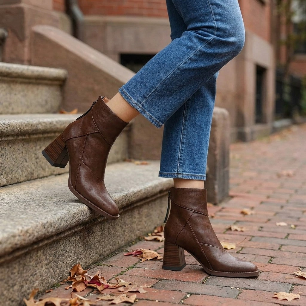 Arona Paneled Ankle Boots — Brown, worn with cropped blue jeans on a brick sidewalk by brownstone steps