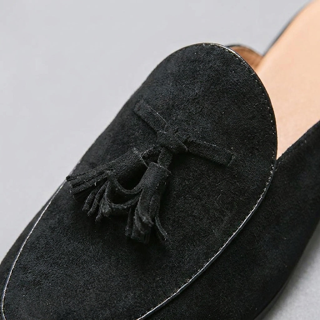 Pienza Suede Mules — Black, close-up tassel and vamp suede texture