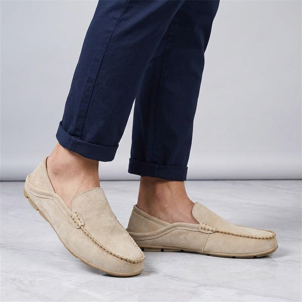 Cervia Suede Loafers — Khaki, worn sockless with cuffed navy chinos, knee-down on light grey marble