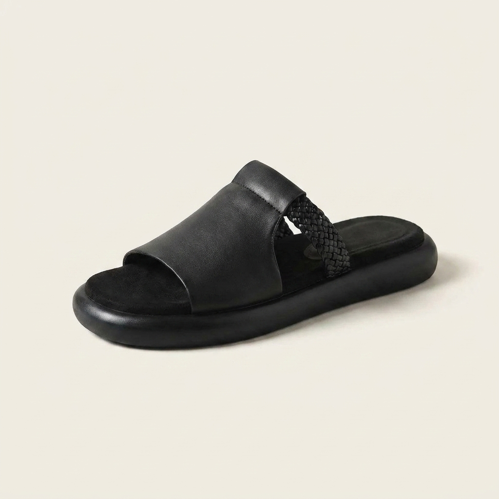 Mykonos Leather Slides — Black, three-quarter studio view