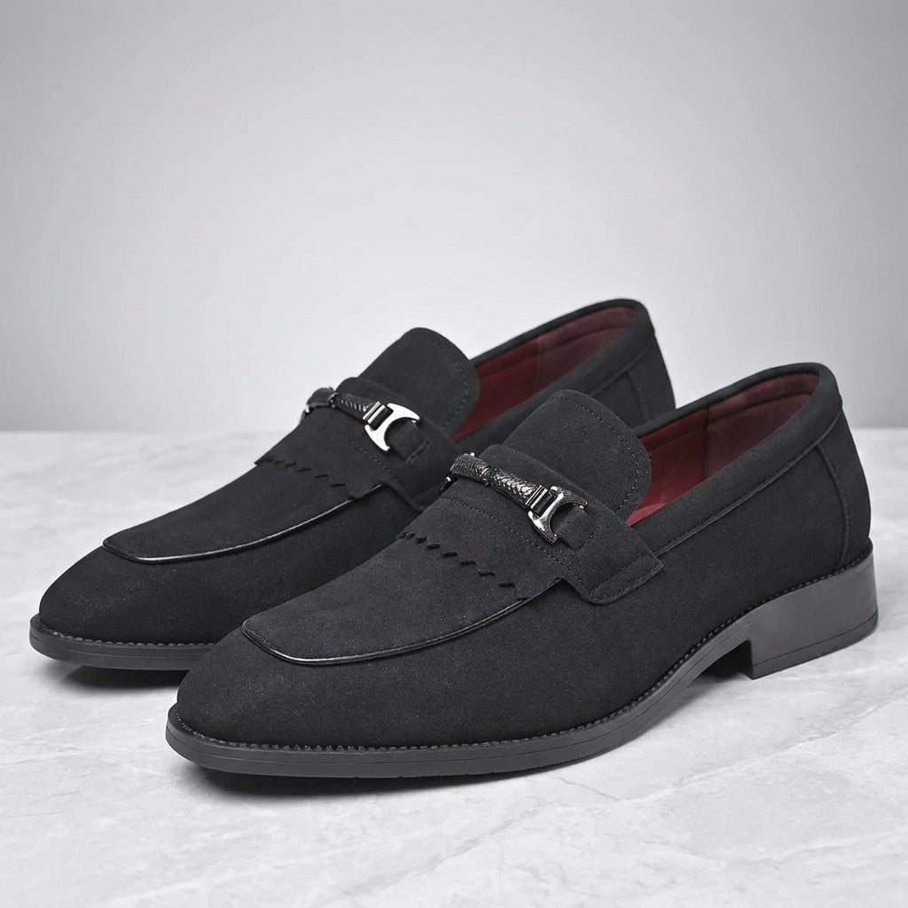 Maratea Kiltie Bit Loafers — Black, pair of kiltie bit loafers, three-quarter view on light grey marble