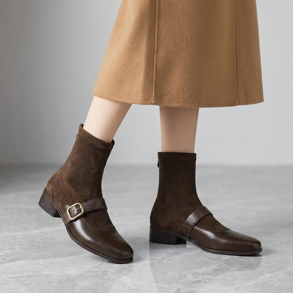 Sondrio Buckled Ankle Boots — Chocolate Brown, worn by a woman, knee down, on grey marble