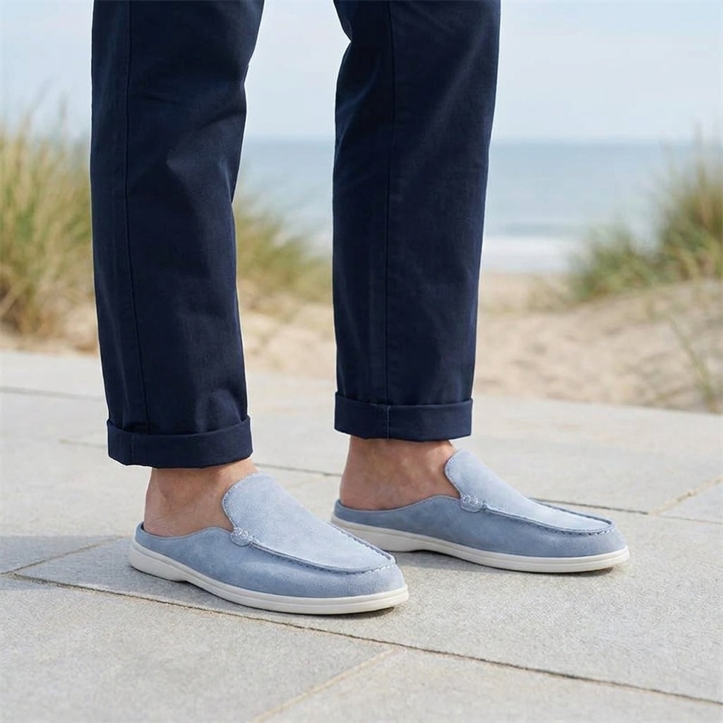 Falmouth Suede Loafers — Blue, male model knee-down coastal pavement