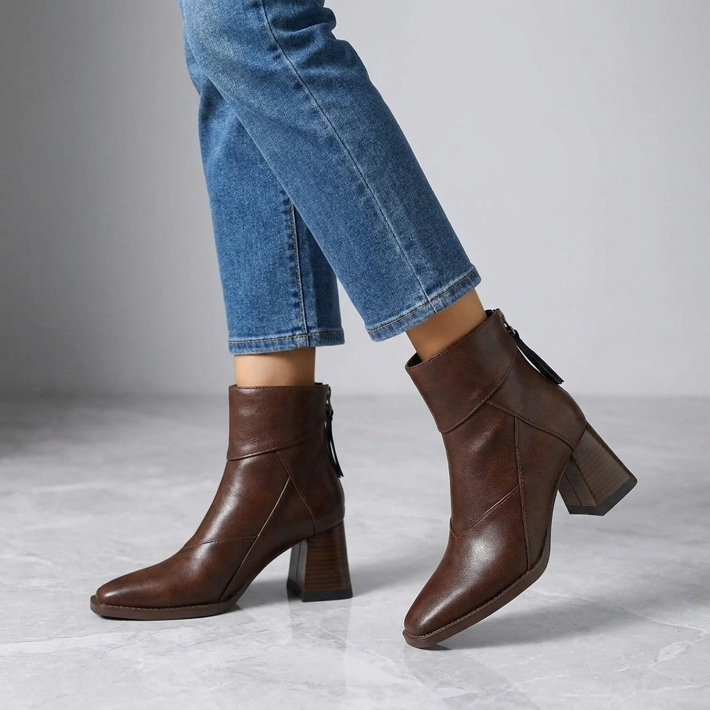 Arona Paneled Ankle Boots — Brown, worn with cropped blue jeans, knee-down on light grey marble