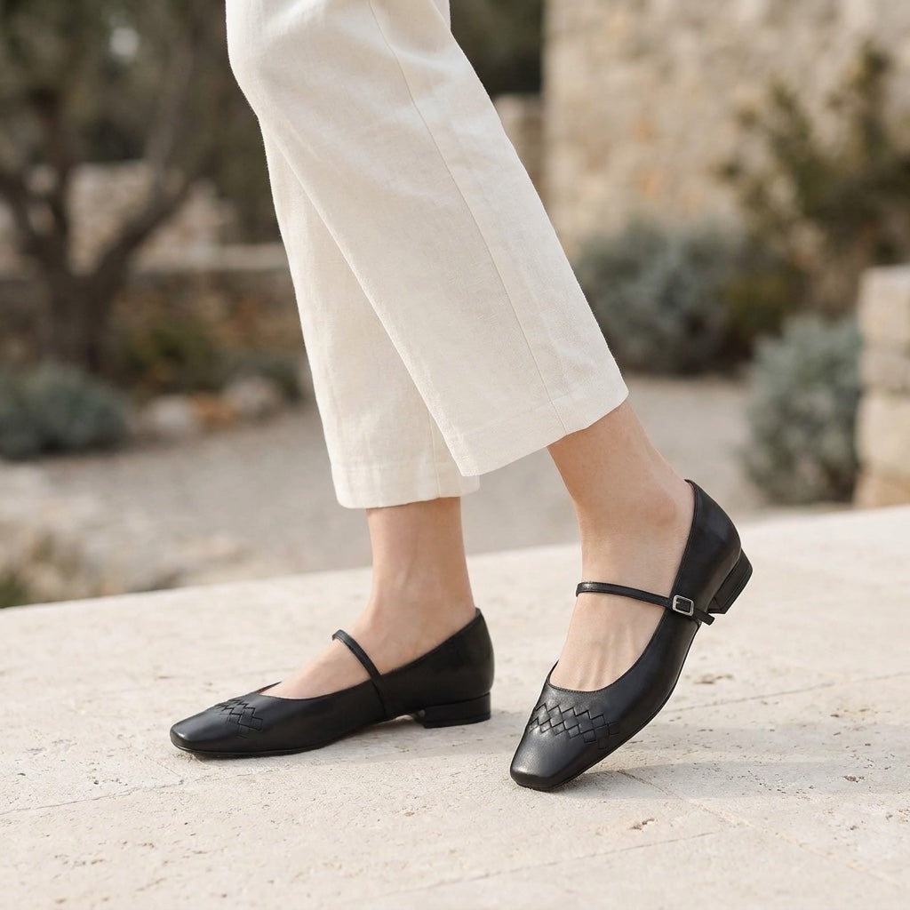 Cremona Mary Janes — Black, worn outdoors on a stone terrace, from the knee down