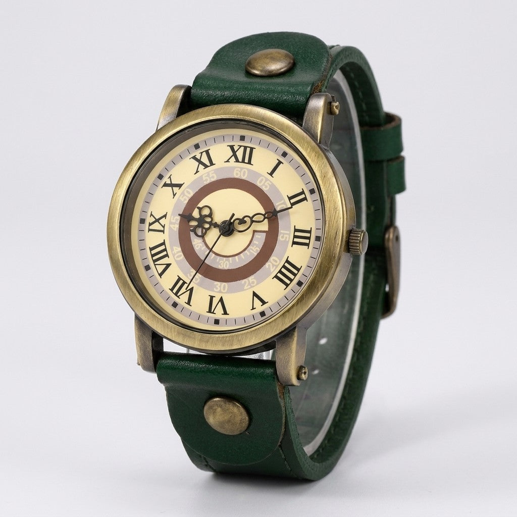 Tarquinia Bronze-Tone Watch — Bronze / Green Leather, cream Roman-numeral dial on a light-grey studio backdrop