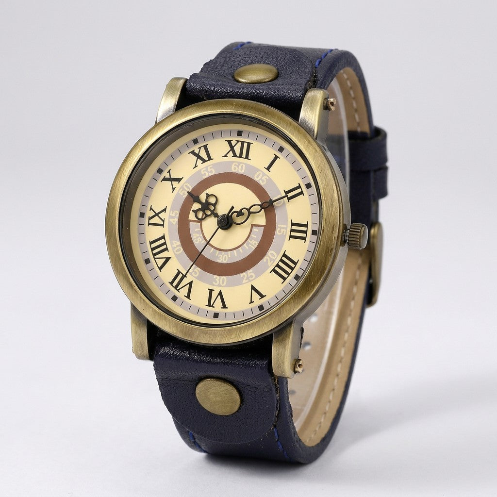 Tarquinia Bronze-Tone Watch — Bronze / Navy, cream Roman-numeral dial on a light-grey studio backdrop