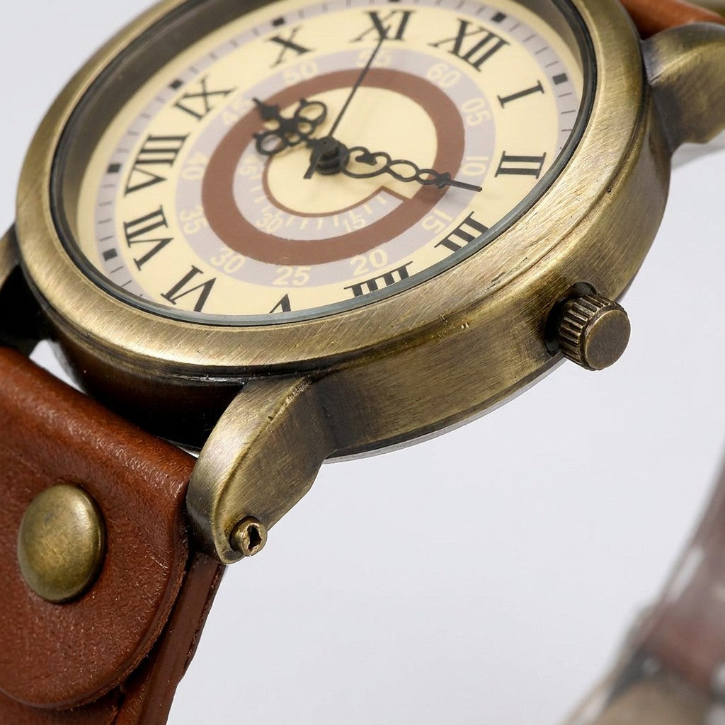 Tarquinia Bronze-Tone Watch — Bronze / Tan, close-up of the bronze-tone case, crown, lug and strap rivet
